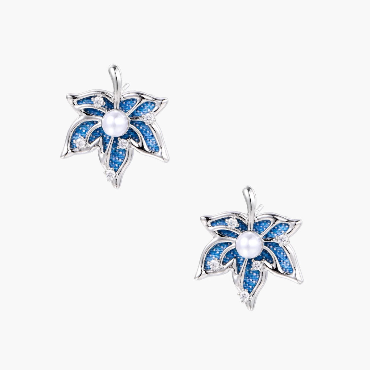 Blue denim fabric star-flower stud earrings with white pearl center and crystal accents on white gold-plated frame