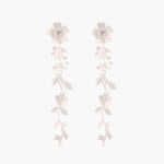 Long sterling silver drop earrings with delicate floral vine design and crystal accents on white background