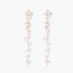 Long sterling silver drop earrings with delicate floral vine design and crystal accents on white background