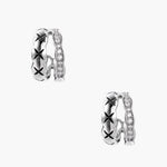 Triple-row white gold hoops with black X-pattern, twisted band, and pavé zirconia stones on white background.