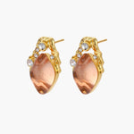 Gold-plated baroque stud earrings with coral-pink liuli stones and cubic zirconia crystals on white background.