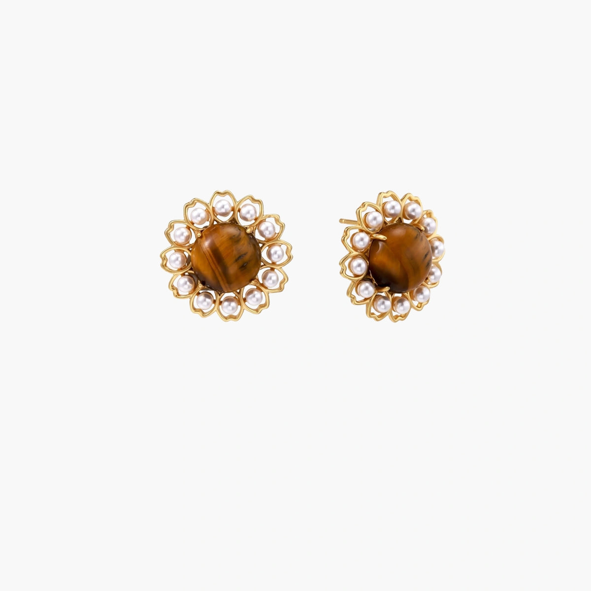 Gold-plated stud earrings with cushion-cut tiger's eye stones surrounded by pearl halos on white background.