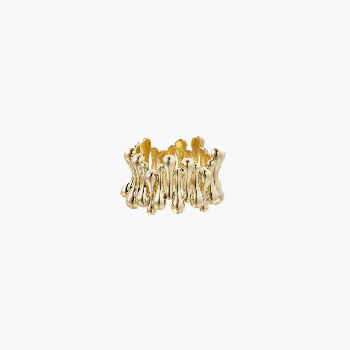 Gold-plated brass ring with sculptural petal-like elements in a wide band design on beige background