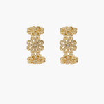 Gold hoop earrings with intricate three-dimensional floral filigree pattern in 14K gold plated brass on cream background
