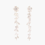 Long sterling silver drop earrings with delicate floral vine design and crystal accents on white background