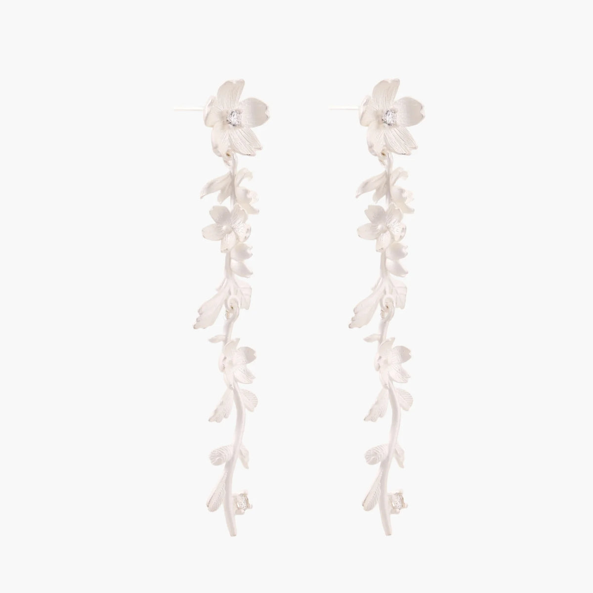 Long sterling silver drop earrings with delicate floral vine design and crystal accents on white background