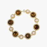 Gold-plated link bracelet with alternating brown tiger's eye stones and white freshwater pearls in ornate bezels.