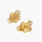 Pair of gold-plated double flower earrings with textured petals and crystal centers on cream background.