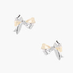 Dimensional bow stud earrings in white gold plated brass with silver and cream two-tone finish on neutral background