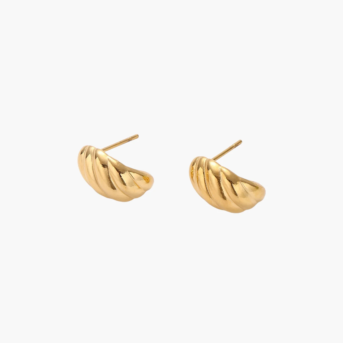 Chunky gold twisted rope huggie hoops with diagonal grooves and high-polish finish on cream background