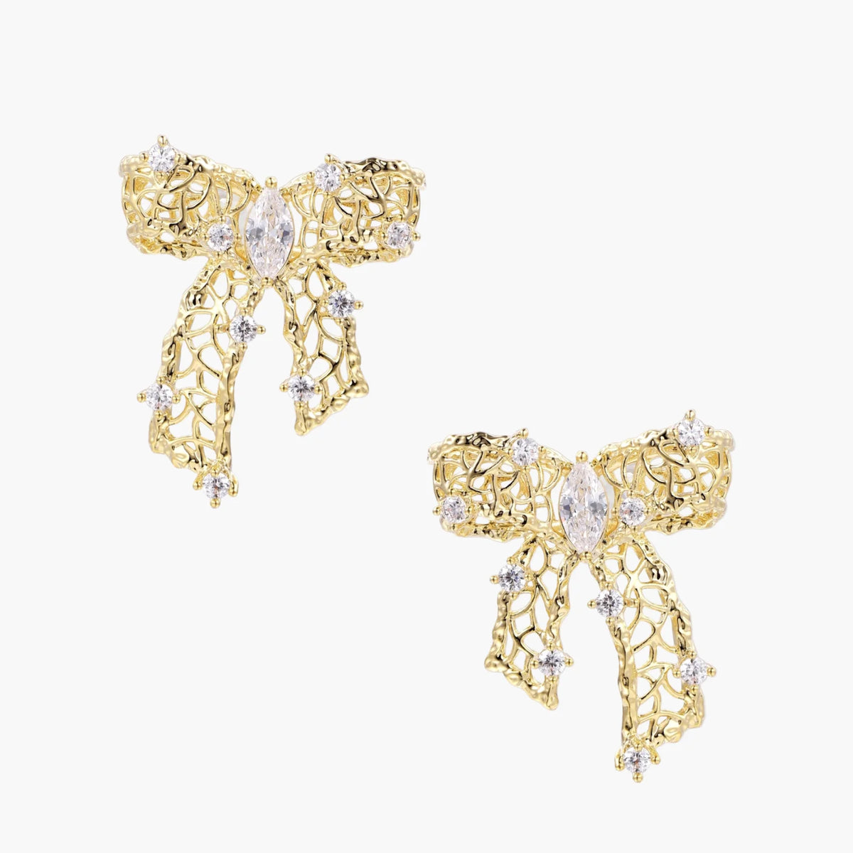 Filigree bow-shaped earrings with marquise center stone and lattice ribbon tails in gold and silver finishes