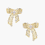 Filigree bow-shaped earrings with marquise center stone and lattice ribbon tails in gold and silver finishes